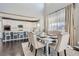 Bright dining area with a large window, stylish furnishings, and hardwood floors adjacent to a modern kitchen at 14881 Rider Pl, Parker, CO 80134