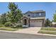 Charming two-story home with stone accents, well-manicured lawn, and a spacious two-car garage, exudes curb appeal at 14881 Rider Pl, Parker, CO 80134