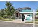 Charming two-story home with stone accents, a well-manicured lawn, and attractive landscaping at 14881 Rider Pl, Parker, CO 80134