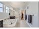 Luxurious main bathroom featuring a soaking tub, separate shower, and elegant tile work throughout at 14881 Rider Pl, Parker, CO 80134