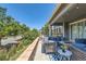 Inviting covered patio with stone surround, a cozy fire pit, and comfortable seating, perfect for outdoor relaxation at 14881 Rider Pl, Parker, CO 80134