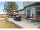 Beautiful back patio with dining set, hot tub, and cozy lounge chair at 4495 Rainbow Ln, Broomfield, CO 80020