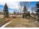 Expansive backyard with wooden play structure and a wooden fence at 4495 Rainbow Ln, Broomfield, CO 80020