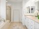 Bathroom featuring a vanity with double sinks, a soaking tub, and a glass-enclosed shower at 4495 Rainbow Ln, Broomfield, CO 80020