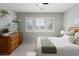 Bedroom featuring a wooden dresser, decor shelving, and a window with shutters at 4495 Rainbow Ln, Broomfield, CO 80020