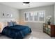 Comfortable bedroom featuring a plush blue bedspread and bright window at 4495 Rainbow Ln, Broomfield, CO 80020