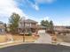 Two-story home with brick accents, a spacious driveway, landscaped yard, and neighborhood views at 4495 Rainbow Ln, Broomfield, CO 80020