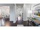 Elegant hallway featuring hardwood floors, neutral walls, decorative lighting, and a view into the dining room at 4495 Rainbow Ln, Broomfield, CO 80020