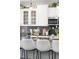 Kitchen island with granite countertops and white bar stools at 4495 Rainbow Ln, Broomfield, CO 80020