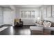 Comfortable living room featuring hardwood floors, a cozy sofa, decorative pillows, and bright natural light at 4495 Rainbow Ln, Broomfield, CO 80020