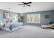 Large main bedroom with light blue walls, a ceiling fan, and a window with shutters at 4495 Rainbow Ln, Broomfield, CO 80020