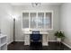 Bright and functional home office with a white desk, comfortable chair, ample natural light, and hardwood floors at 4495 Rainbow Ln, Broomfield, CO 80020