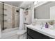 Bright bathroom featuring tiled walls, updated vanity, and shower-tub combination at 6940 E Girard Ave # 210, Denver, CO 80224