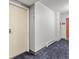 Hallway with unit number and door, showing access to the residential space at 6940 E Girard Ave # 210, Denver, CO 80224
