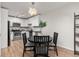 Eat in kitchen featuring white cabinets, stainless steel appliances, and a black table with seating for four at 6940 E Girard Ave # 210, Denver, CO 80224