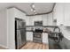 Modern kitchen with stainless steel appliances, sleek white cabinets, subway tile backsplash, and dark countertops at 6940 E Girard Ave # 210, Denver, CO 80224