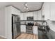 Bright kitchen with stainless steel appliances, granite countertops, white cabinets, and subway tile backsplash at 6940 E Girard Ave # 210, Denver, CO 80224