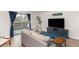 Bright living room with a balcony, plush couch, stylish console, and a modern decor at 6940 E Girard Ave # 210, Denver, CO 80224
