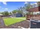 Large backyard featuring a deck, a shed, and a well-maintained lawn at 1238 Rosemary St, Denver, CO 80220