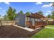 Landscaped backyard featuring a wood deck with a pergola and a well-maintained lawn at 1238 Rosemary St, Denver, CO 80220