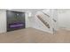 Finished basement featuring modern flooring, a stylish electric fireplace, and staircase at 1238 Rosemary St, Denver, CO 80220