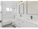 Elegant bathroom featuring a double vanity, modern fixtures, and a tiled shower-tub combo at 1238 Rosemary St, Denver, CO 80220
