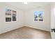Bright bedroom with hardwood floors and two windows offering lots of natural light at 1238 Rosemary St, Denver, CO 80220