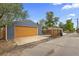 Detached one-car garage with alley access and a concrete driveway for additional parking at 1238 Rosemary St, Denver, CO 80220