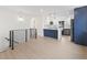 Bright kitchen featuring stainless appliances, white cabinets, and a contrasting blue breakfast bar at 1238 Rosemary St, Denver, CO 80220