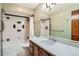 Bathroom featuring a granite-topped vanity and a shower-tub combination at 1408 W Briarwood Ave, Littleton, CO 80120