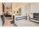 Well-lit bathroom with double sinks, soaking tub, and adjacent bedroom at 1408 W Briarwood Ave, Littleton, CO 80120