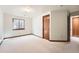 Cozy bedroom features a window with blinds, neutral walls and trim, and carpet floors at 1408 W Briarwood Ave, Littleton, CO 80120