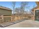 Spacious wooden deck overlooking backyard with trees and some visible views at 1408 W Briarwood Ave, Littleton, CO 80120