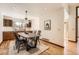 Cozy dining area next to kitchen featuring modern lighting and hardwood flooring at 1408 W Briarwood Ave, Littleton, CO 80120