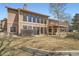 Two-story home boasts large windows, a wood-paneled exterior, and an elevated wood deck at 1408 W Briarwood Ave, Littleton, CO 80120