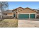 Charming home featuring a stone facade, two-car garage with green doors, and well-maintained lawn at 1408 W Briarwood Ave, Littleton, CO 80120