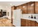 Modern kitchen with white appliances, plenty of cabinet space, and adjacent dining area at 1408 W Briarwood Ave, Littleton, CO 80120