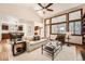 Inviting living area featuring large windows, hardwood flooring, and an open floor plan at 1408 W Briarwood Ave, Littleton, CO 80120