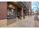 Street-level view of a brick building with Usaj Realty signage and convenient street access at 1499 Blake St # 1F, Denver, CO 80202