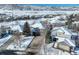 Aerial shot of a neighborhood covered in snow, showcasing well-maintained homes and winter scenery at 10914 W Coco Pl, Littleton, CO 80127