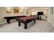 Basement featuring a pool table, shuffleboard table, media area, and bar seating at 10914 W Coco Pl, Littleton, CO 80127