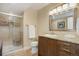 Bathroom with glass door shower, granite countertop, updated vanity, and tile flooring at 10914 W Coco Pl, Littleton, CO 80127