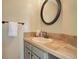 Cozy bathroom with a vanity, mirror, light fixtures and tiled countertop at 10914 W Coco Pl, Littleton, CO 80127