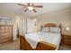 Bedroom with wooden furniture set, ceiling fan, and carpeted floors at 10914 W Coco Pl, Littleton, CO 80127