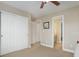 This bedroom includes closet doors, access to a bathroom, and neutral walls at 10914 W Coco Pl, Littleton, CO 80127