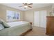 Comfortable bedroom featuring a ceiling fan, neutral colors, and a large window at 10914 W Coco Pl, Littleton, CO 80127