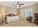 Cozy bedroom with a ceiling fan, daybed, wicker chair, and a bright window at 10914 W Coco Pl, Littleton, CO 80127