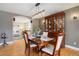 Charming dining room with hardwood floors, a modern light fixture, and a large china cabinet at 10914 W Coco Pl, Littleton, CO 80127