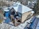 Aerial shot of a home with a backyard deck and hot tub covered in snow at 10914 W Coco Pl, Littleton, CO 80127