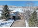 Stunning two-story home with a three-car garage and snow-covered roof, set against a beautiful mountain backdrop at 10914 W Coco Pl, Littleton, CO 80127